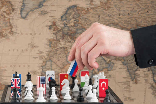 politicians-hand-moves-chess-piece-with-flag