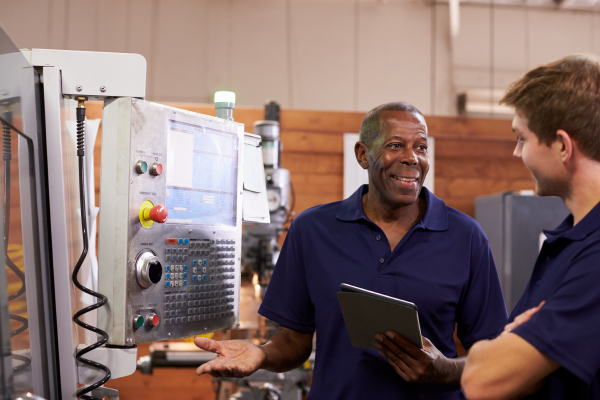 engineer-training-male-apprentice-on-cnc-machine