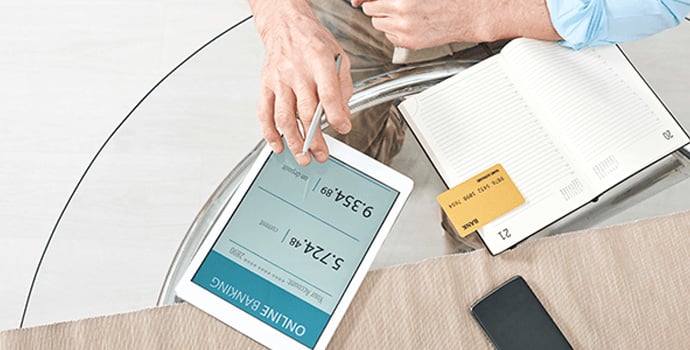 hands-of-retired-man-with-digital-tablet-and-bank-1-1